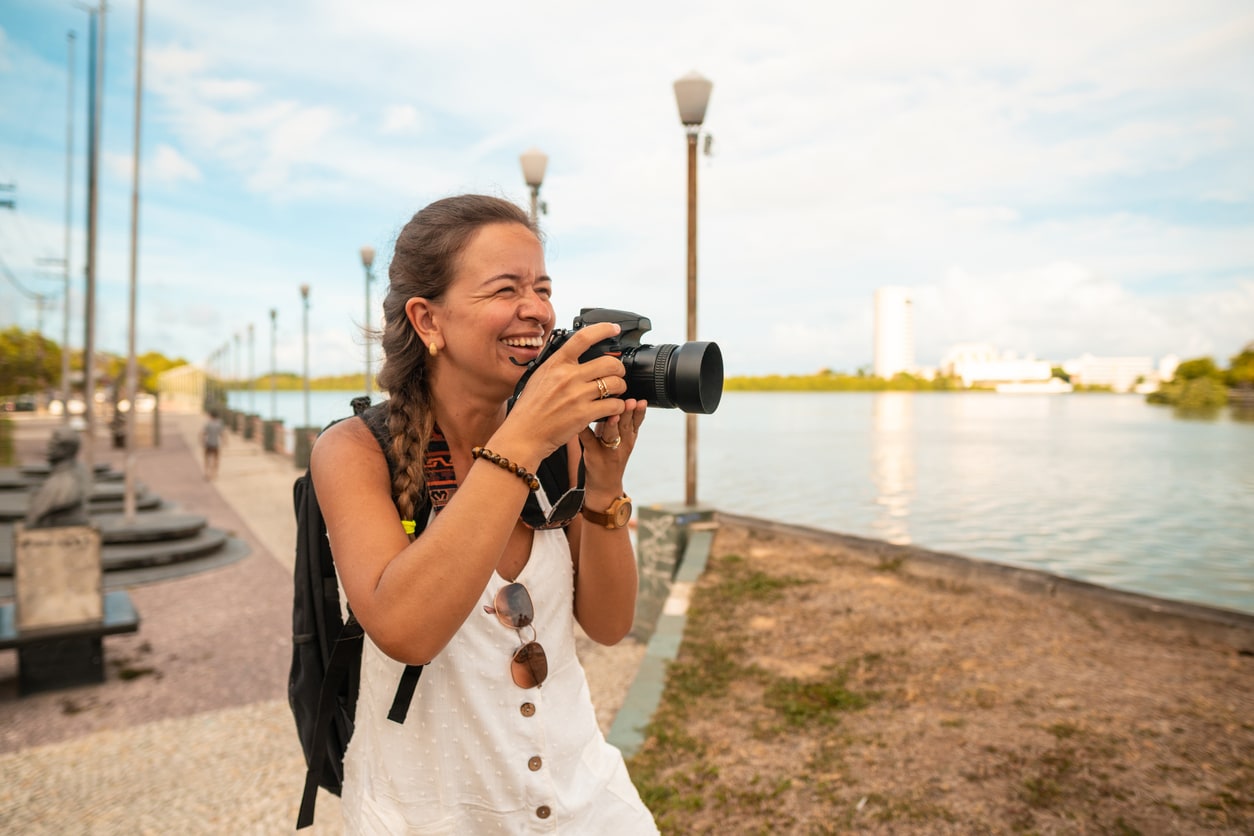 Woman photographs Capibaribe River